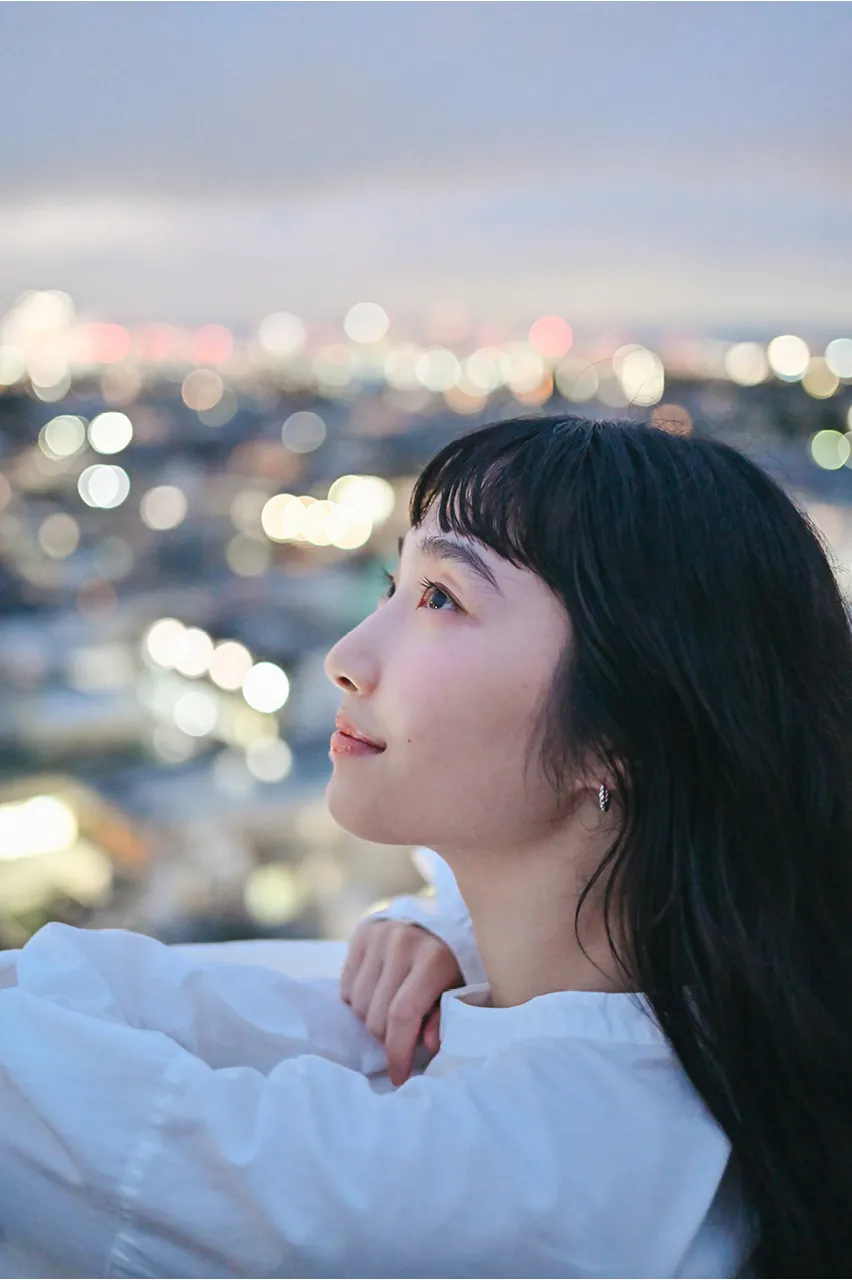 Official Nikon Z5IIC sample photo: twilight portrait with city light bokeh on 40mm f/2